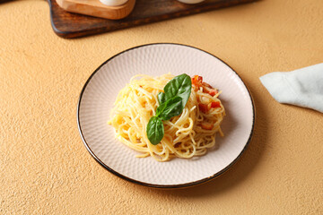 Plate with tasty pasta carbonara on beige background