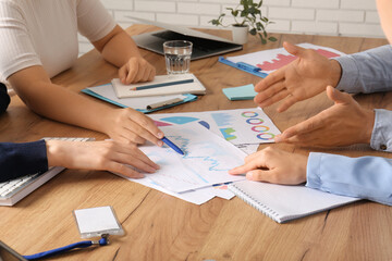 Business team working with graphics during meeting in office, closeup
