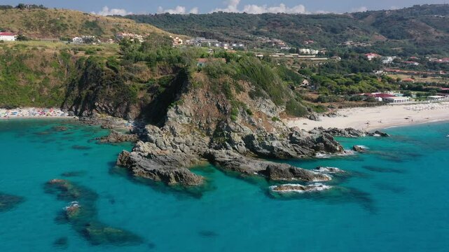 Aerial view of sea and rocky beach in Marinella Di Zambrone on a sunny summer day in Calabria, Italy