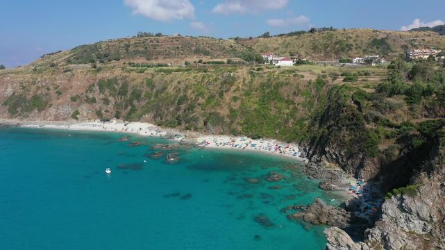 Aerial view of sea and rocky beach in Marinella Di Zambrone on a sunny summer day in Calabria, Italy