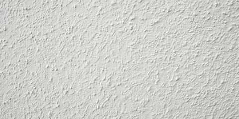 Fototapeta premium Close-up view of a textured white exterior wall with a rough, uneven surface and a subtle pattern of raised dots and bumps