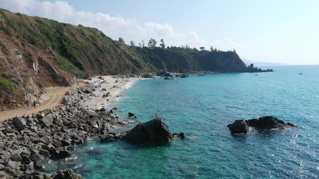 Aerial view of sea and rocky beach in Marinella Di Zambrone on a sunny summer day in Calabria, Italy