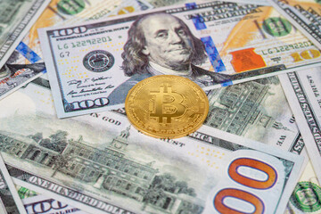 Close-up view of bitcoin coin and dollar bills. The virtual currency of the future.