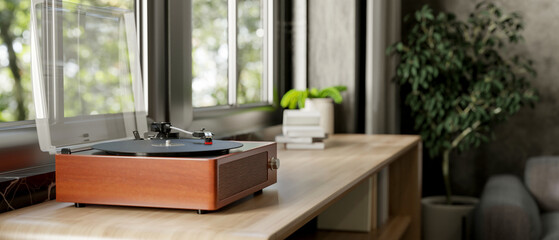 Fototapeta premium A vintage wooden record vinyl player on a wooden cabinet by the window in a contemporary living room