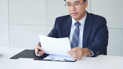 Businessman hands note meeting document in conference room. man Hands writing planning notebook. Close up male hand holding pencil write on diary sketchbook at office desk. Business Planning Concept