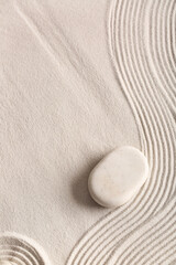 Stone on light sand with lines. Zen concept