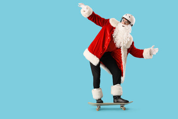 Young Santa Claus in helmet skating on blue background © Pixel-Shot