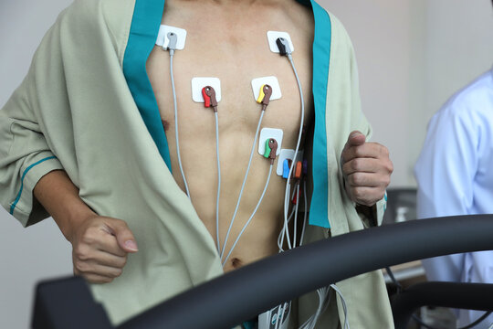 Heart electrocardiogram or monitoring using Holter for young patient. Male athlete does a cardiac stress test. wearing Holter monitor device for daily monitoring of an electrocardiogram.