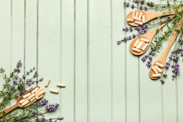 Composition with pills and fresh herbs on green wooden background