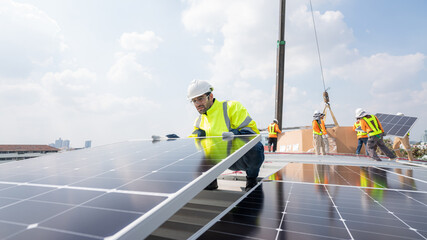 Engineer service check installation solar cell on the roof of factory. Silhouette technician...