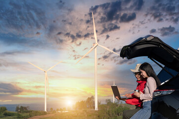 Asian male and female engineers in casual uniforms are using a laptop to examine the work at the...