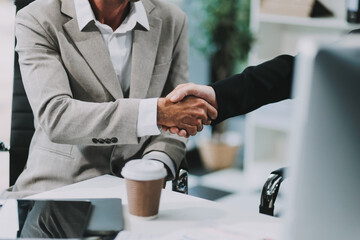 Business investor group holding hands, Two businessmen are agreeing on business together and shaking hands after a successful negotiation. Handshaking is a Western greeting or congratulation.