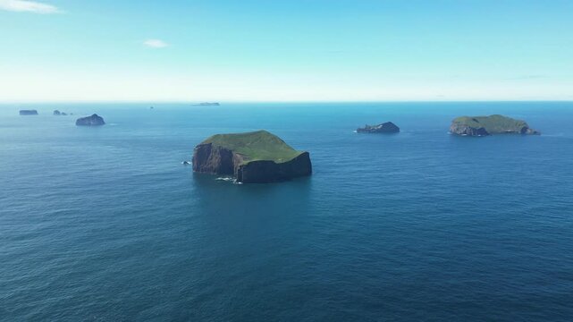 Dolly forward view of secluded islets on Iceland archipelago, inhabited nook house on cliffs