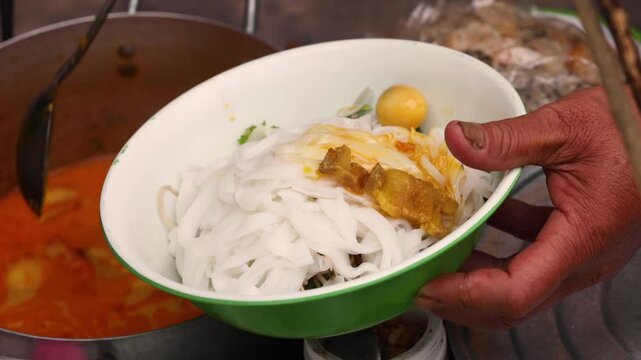 Asian street food. The process of making Vietnamese food Cao Lau this is a Vietnamese noodle bowl that includes greens, noodles, and various key ingredients. Fresh greens.