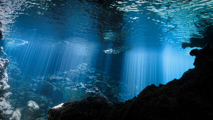 Underwater photo of a dreamlike and etheral environment. From cave scuba dive in rays of sunlight in Thailand.