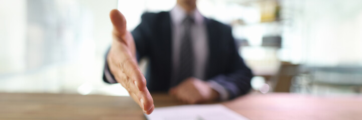 Obraz premium Successful businessman stretches out hand to do handshake