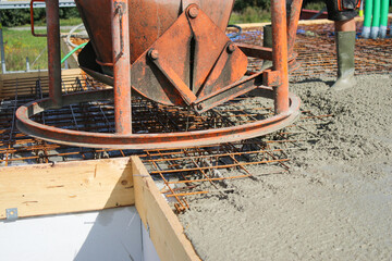 Workers filling the second floor ground with concrete, core and shell construction building 