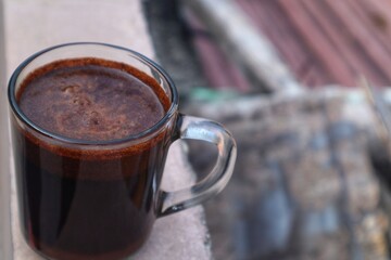 Black Coffee drink in a clear glass, close up view.