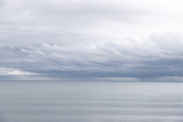 Silvery overcast ocean horizon with calm water Minimal beauty