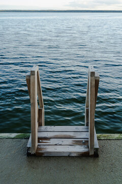 Wooden ladder into the cold blue sea