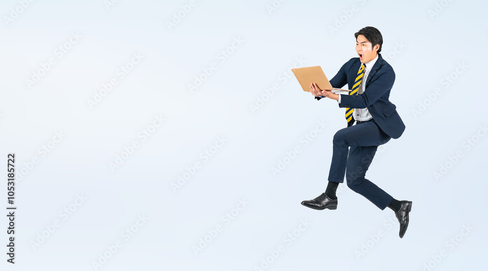 Aufkleber ノートパソコンを使いながらジャンプする若い男性ビジネスパーソンの全身写真（切り抜き背景透過pngも販売しております。作成者リンクから「png」で検索してください）