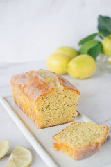 freshly baked homemade lemon poppy seed pound cake on white ceramic tray.