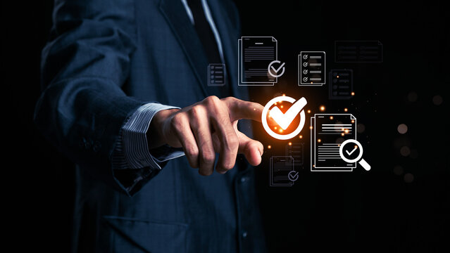 Businessman makes a checklist Assessment and questionnaire, businessman using tablet to do online survey online digital form Show green check mark Choose the correct answer on the exam.