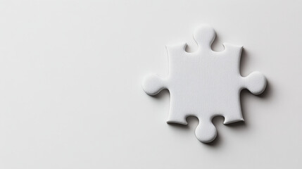 Obraz premium Single White Puzzle Piece: A solitary white puzzle piece stands out against a minimalist background, symbolizing the missing piece, the crucial element, or the potential for completion. 