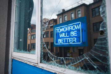 Obraz premium Broken window with a view of a neon that says tomorrow will be better