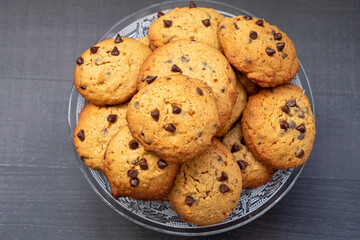 A bowl of chocolate chip cookies with a lot of chocolate chips
