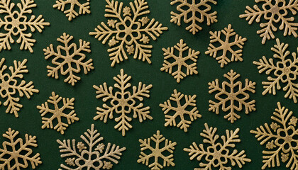 キラキラしたグリッターの金色の雪の結晶、緑色の背景