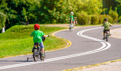 Cyclists ride on the bike path in the city Park
