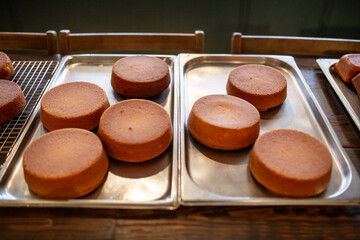 Freshly Baked Cake Layers Cooling on Rustic Table