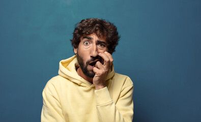 open-mouthed in shock and disbelief, with hand on cheek and arm crossed, feeling stupefied and amazed