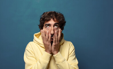 feeling shocked and scared, looking bored with hands on cheeks