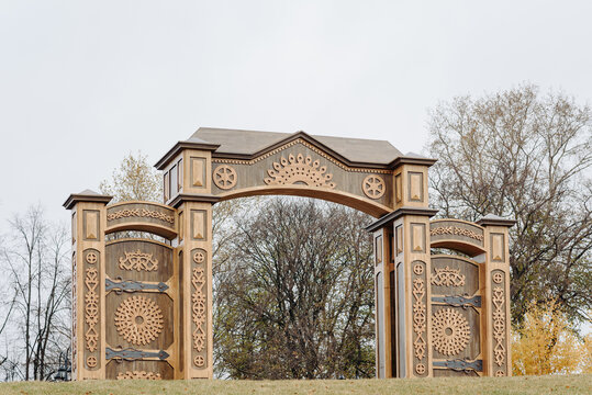 Russian North Gates, large wooden gates with decorative ornament, art-object of Vyatka wooden architecture using wood carving, area fof tourists, located in Kirov, Russia