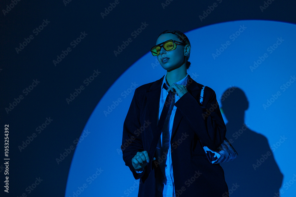 Wall mural beautiful glamorous business lady with yellow glasses in fashion clothes with blazer and tie in stud