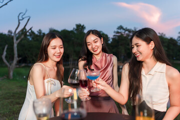 Asian women celebrating, meeting and chatting in a bar. Places to visit, beautiful lights