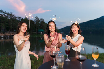Asian women celebrating, meeting and chatting in a bar. Places to visit, beautiful lights