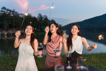 Asian women celebrating, meeting and chatting in a bar. Places to visit, beautiful lights