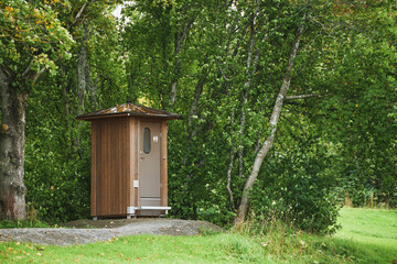 Public restroom amidst dense forest trees