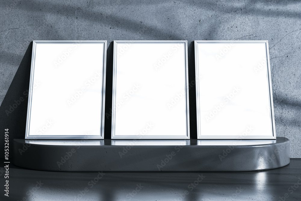 Poster Three empty white frames on pedestal. Gray concrete wall background. Mock up concept. 3D Rendering.