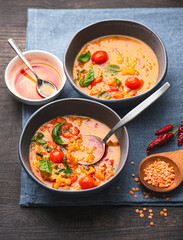 Turkish Red Lentil Soup (Kırmızı Mercimek Çorbası) with vegetables, tomatoes. mint, cumin and spicy olive oil. Mediterranean healthy recipes vegetarian cuisine