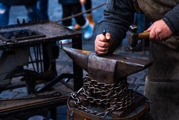 Blacksmith working on metal on anvil. Detail shot. Blacksmith tools. Folk art.