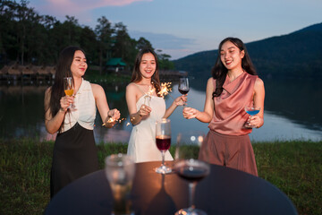 Asian women celebrating, meeting and chatting in a bar. Places to visit, beautiful lights