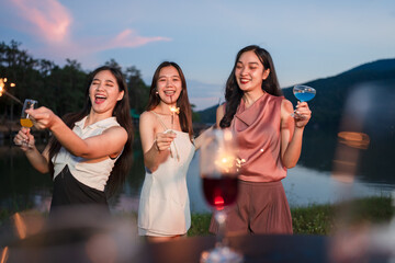 Asian women celebrating, meeting and chatting in a bar. Places to visit, beautiful lights