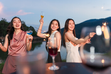 Asian women celebrating, meeting and chatting in a bar. Places to visit, beautiful lights