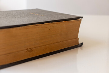 black leather cover of a book. yellowed natural paper texture. The photo was taken on a white background. isolated clean close-up.