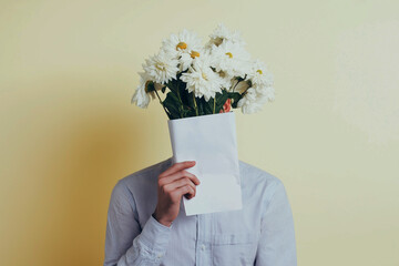 A person holding white flowers in front of their face