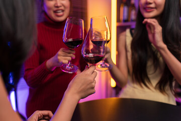 Asian women celebrating, meeting and chatting in a bar. Places to visit, beautiful lights